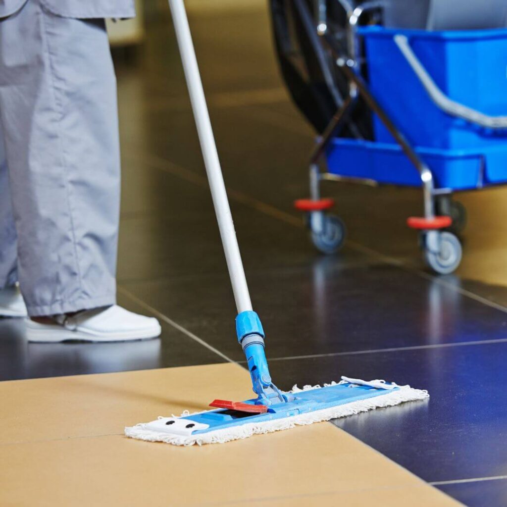 Janitor cleaning the floor of a hospital