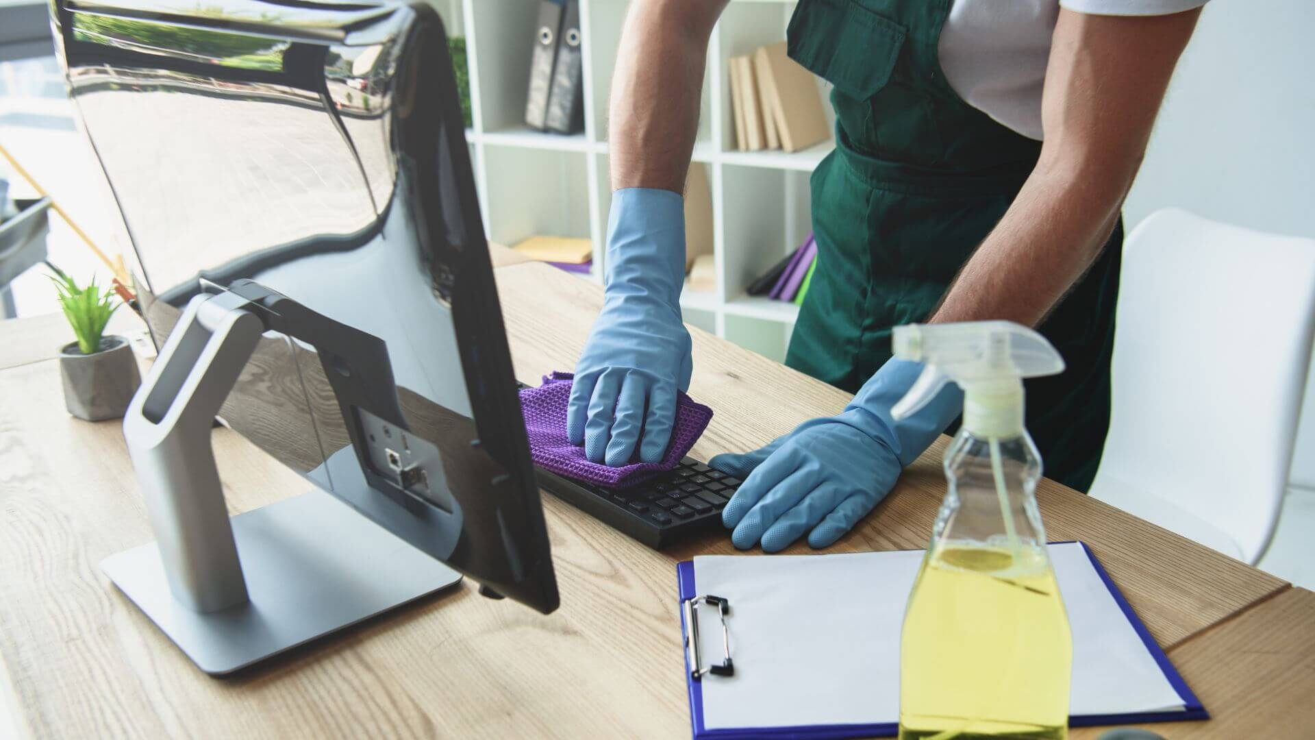 professional cleaner cleaning computer keyboard