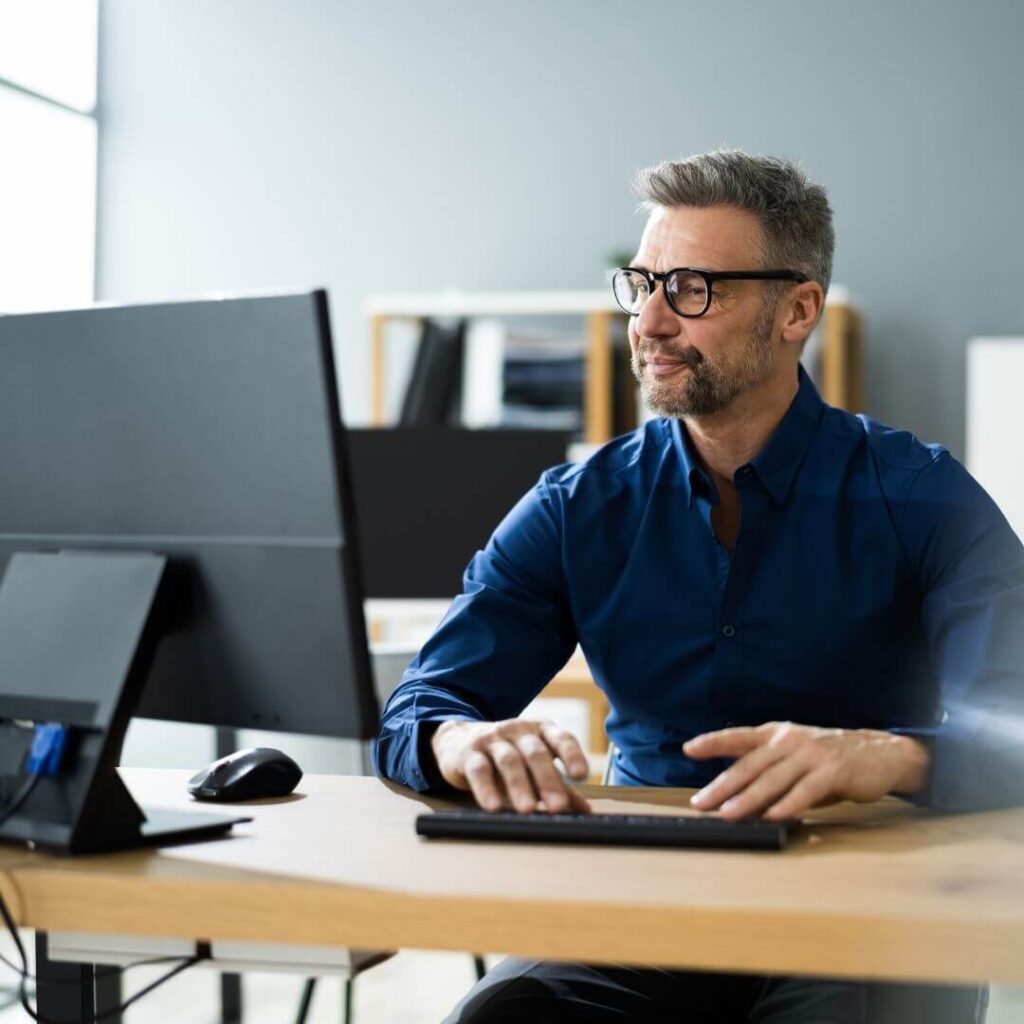 man working on computer in productive workspace