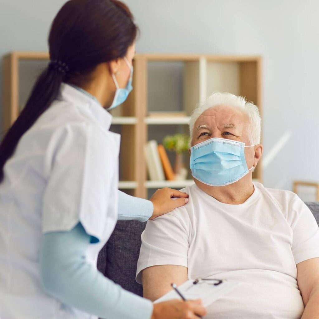 An old man speaking with a doctor